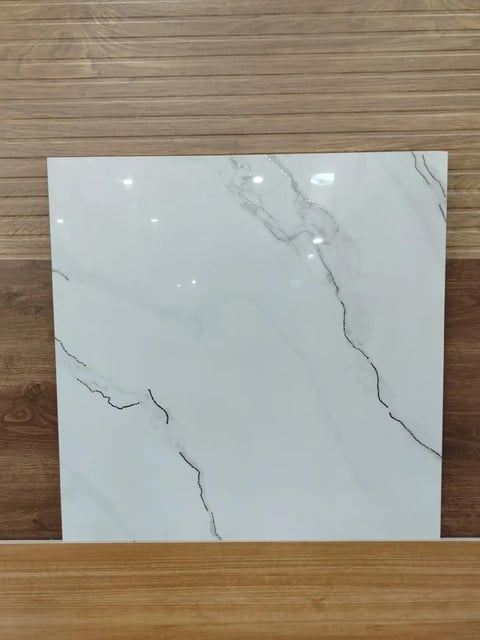 White marble tile with gray veining displayed on wooden floor