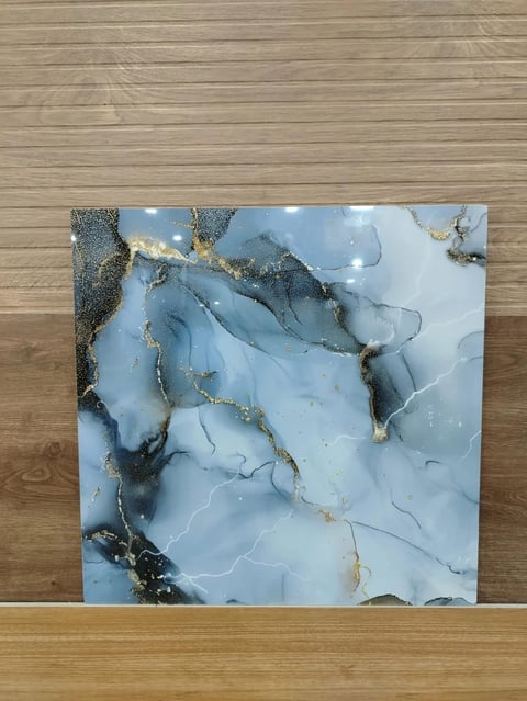 Abstract artwork on wood featuring blue marble texture with gold and black veining accents