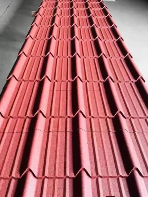 Red corrugated metal roof tiles arranged in overlapping rows