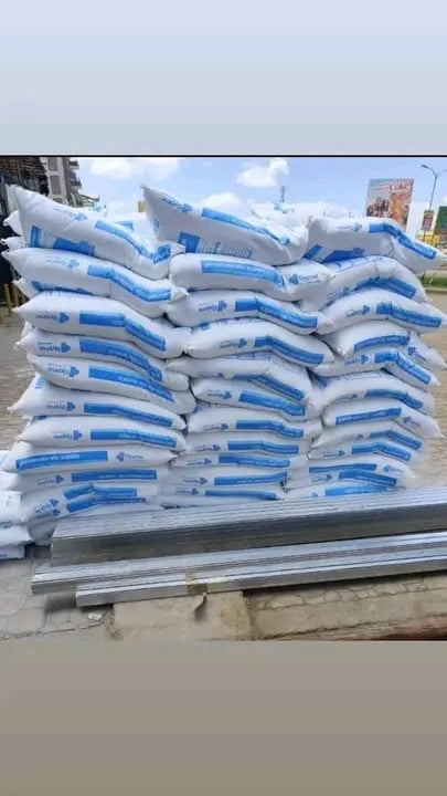 Stack of white and blue bags on a metal pallet in an outdoor industrial or commercial setting