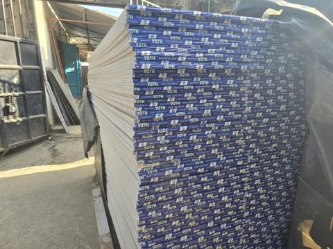 Stack of blue and white branded boxes or packages stacked on a pallet in an industrial warehouse or storage facility