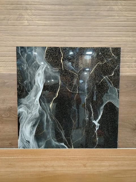 Abstract artwork with flowing white lines and glowing lights on dark starry background, propped on wooden floor