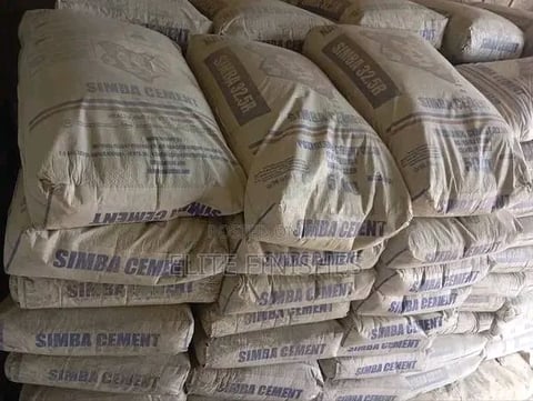 Stacked bags of Simba cement with printed labels, viewed from above in a warehouse or storage setting