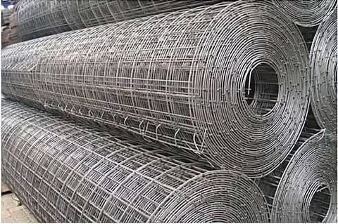 Rolled metal welded wire mesh or fencing stacked in rows for storage or delivery