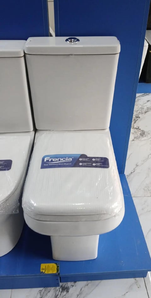 White Frencia toilet on blue display platform in showroom with tank and seat visible