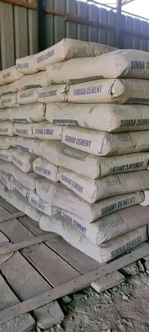 Stacked bags of Simba cement on a wooden pallet in an industrial warehouse setting