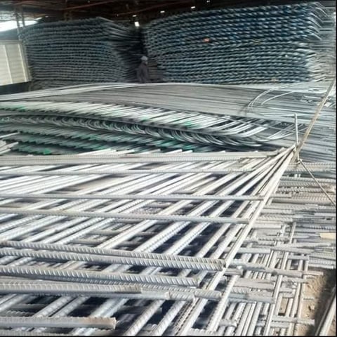 Industrial storage warehouse with stacked metal roofing sheets