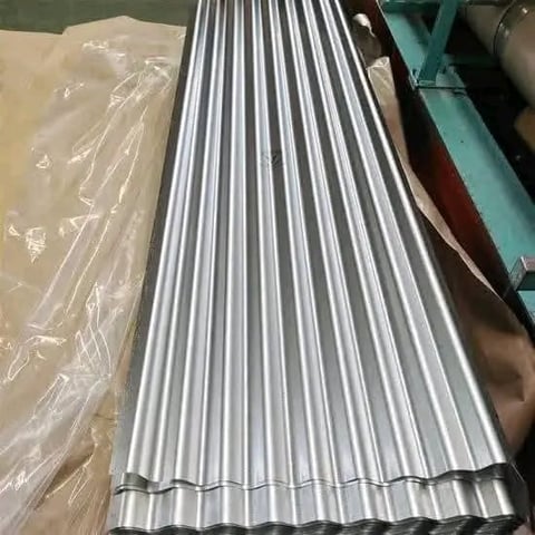 Corrugated metal sheets stacked in warehouse with plastic-wrapped materials nearby