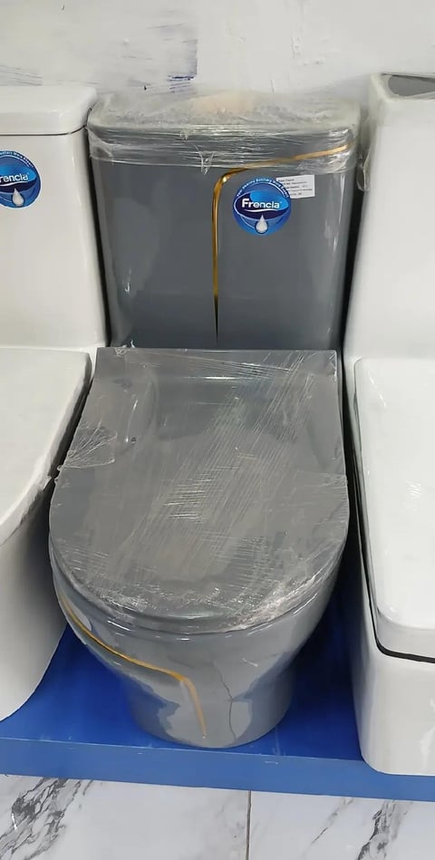 New Francis brand toilet with plastic wrapping, displayed in showroom with white and blue packaging