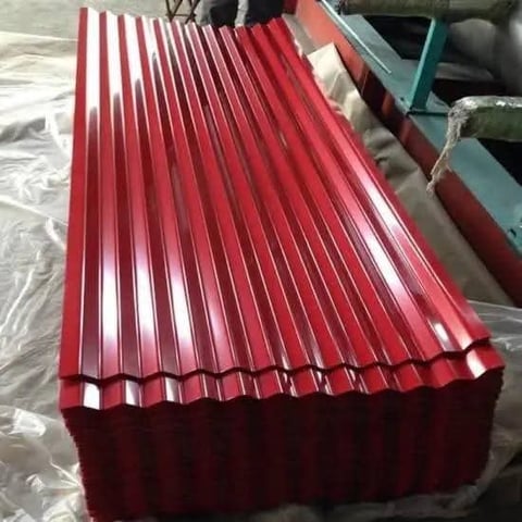 Stack of red corrugated metal roofing sheets with vertical ribbed pattern